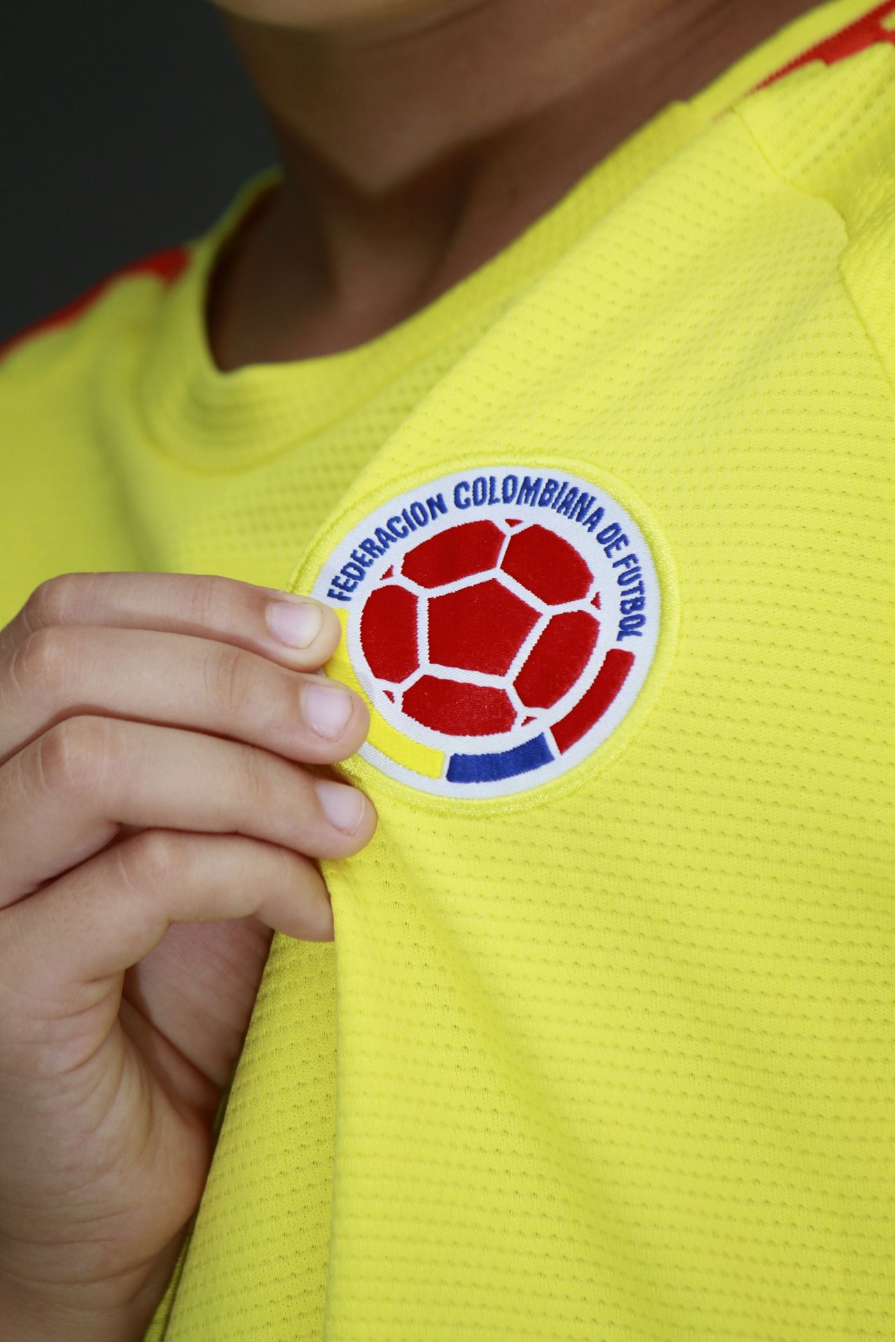 a close up of a person wearing a yellow shirt